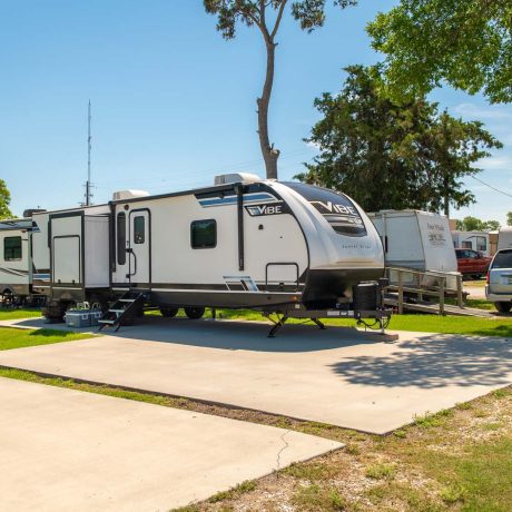 parked camper trailer at Lost River RV Park with grassy lots and clean concrete rv spaces