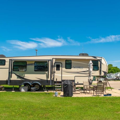 parked camper trailer at Lost River RV Park with grassy lots and clean concrete rv spaces